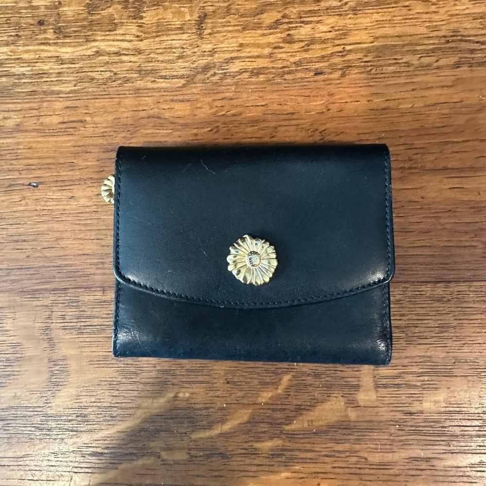 Black leather wallet with a red interior.